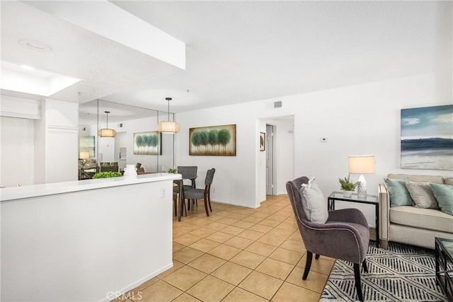 living area featuring light tile patterned floors and visible vents