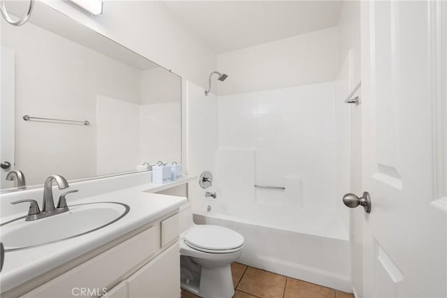 full bathroom with washtub / shower combination, vanity, tile patterned floors, and toilet