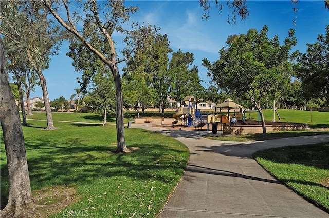 view of home's community featuring a playground and a lawn