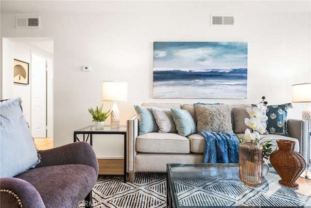 living area featuring wood finished floors and visible vents