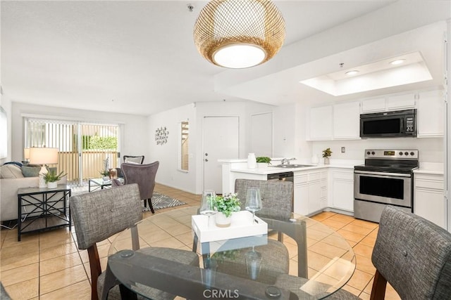 kitchen with electric range, white cabinets, sink, and a tray ceiling