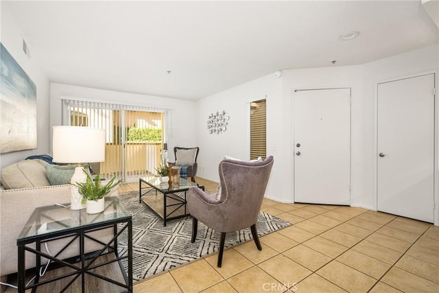 living room with light tile patterned floors and visible vents