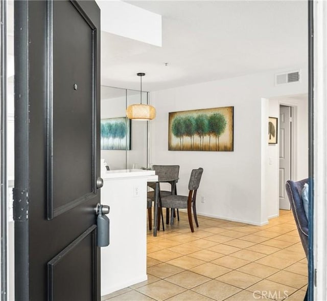 dining area featuring light tile patterned floors