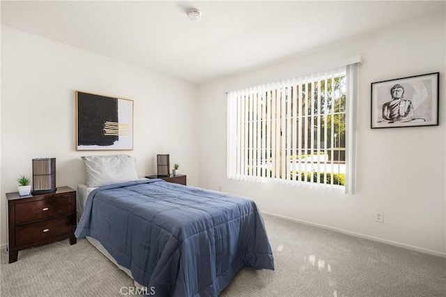 bedroom featuring light carpet and multiple windows