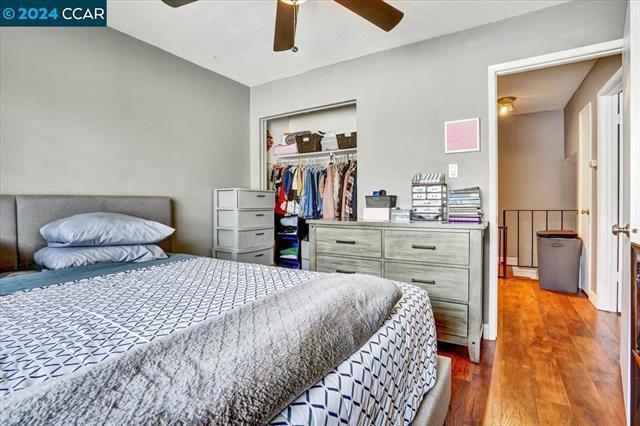 bedroom featuring ceiling fan, a closet, and hardwood / wood-style flooring