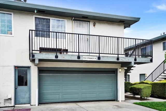 view of front of house featuring a garage and a balcony