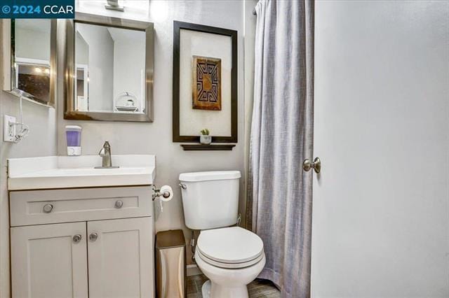 bathroom featuring toilet and vanity