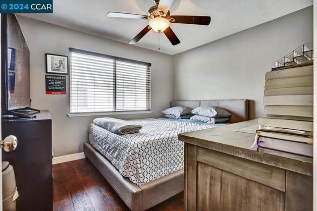 bedroom featuring ceiling fan and dark hardwood / wood-style flooring