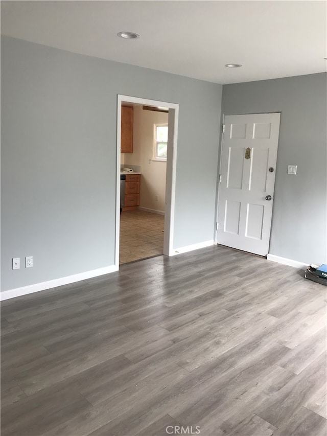 spare room featuring wood-type flooring