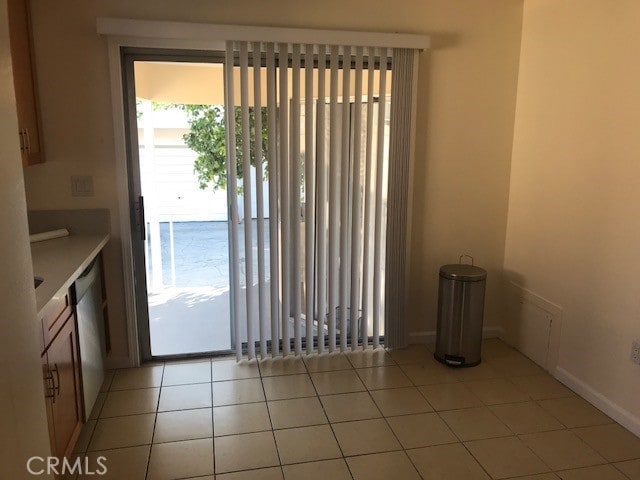 interior space featuring light tile patterned flooring and stainless steel dishwasher