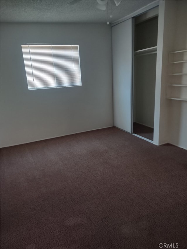 unfurnished bedroom featuring a closet, carpet flooring, and ceiling fan