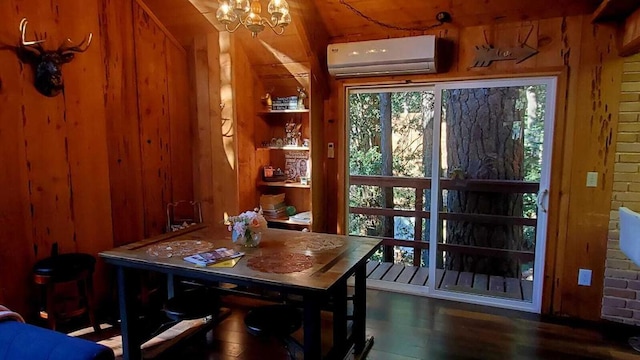 dining room featuring a chandelier, dark hardwood / wood-style flooring, a wall mounted AC, and wood walls