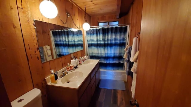 bathroom featuring vanity, toilet, wooden ceiling, and wood walls