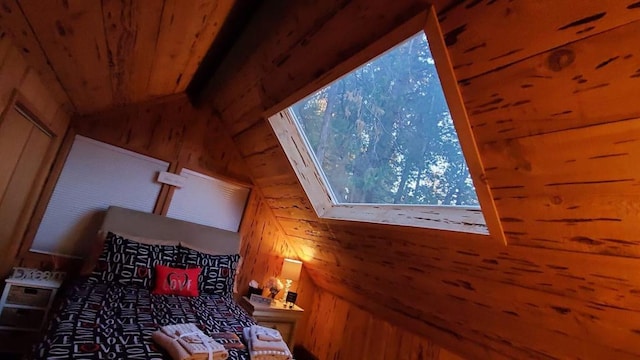 unfurnished bedroom featuring lofted ceiling with skylight, wooden ceiling, and wooden walls