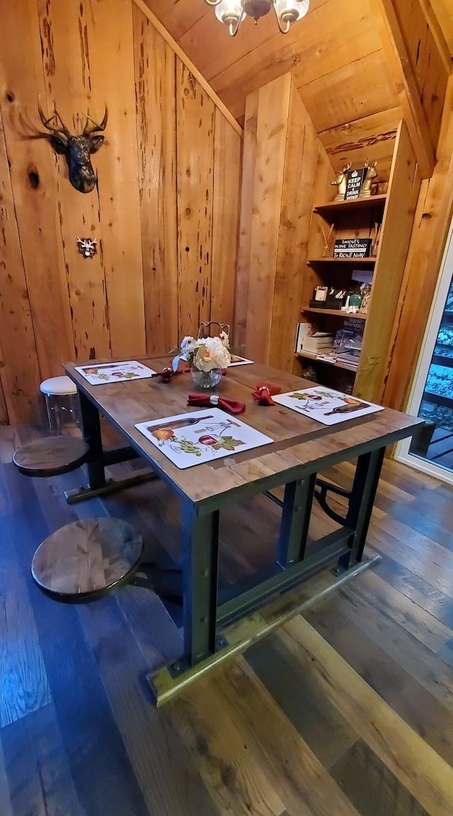 dining room with wood ceiling, wooden walls, and hardwood / wood-style flooring