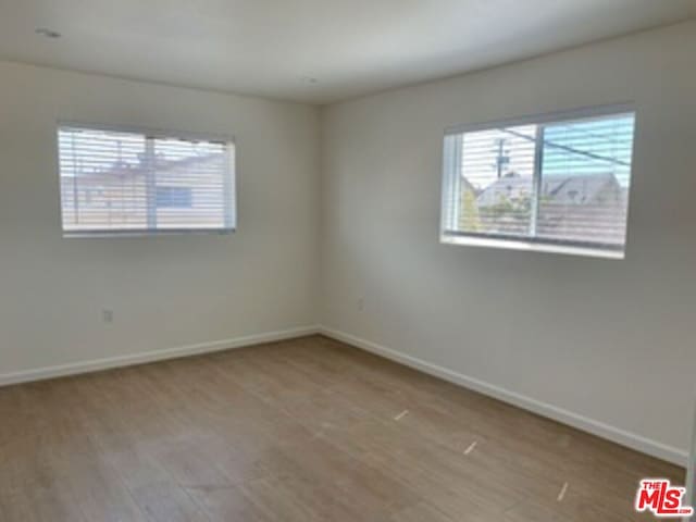 spare room featuring light wood-type flooring