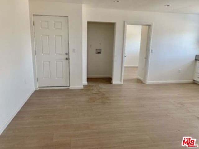 spare room featuring light wood-type flooring