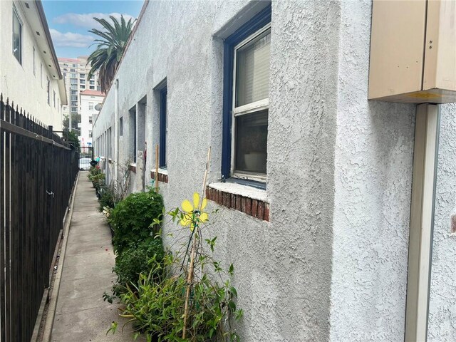 833 E 1st St, Long Beach, CA 90802 - view of side of property featuring stucco siding and fence