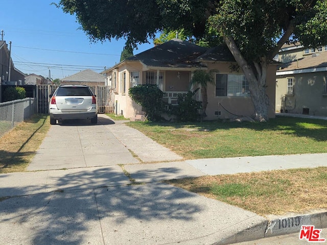 bungalow-style home featuring a front lawn