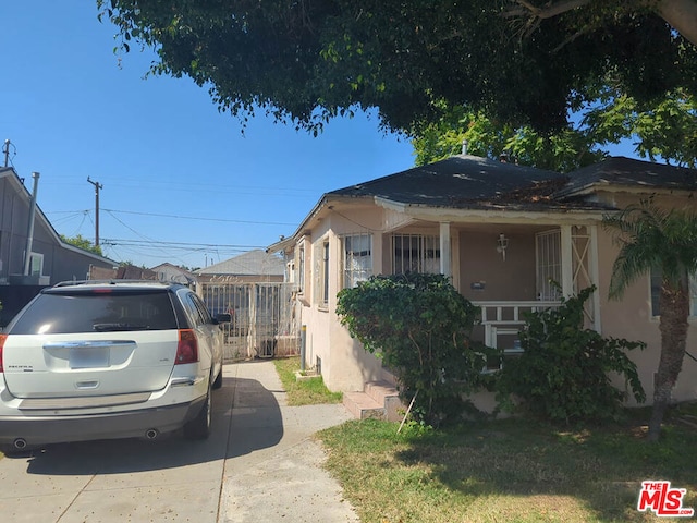 view of side of home with covered porch