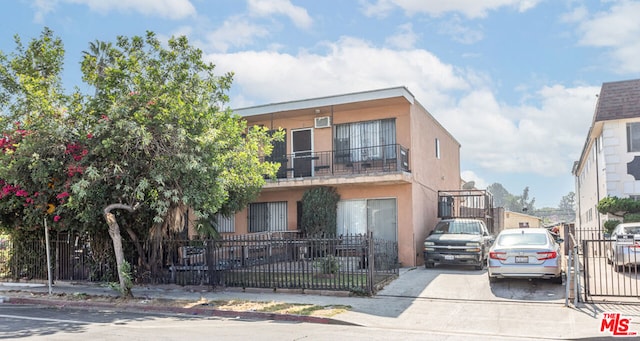 view of front of home featuring a balcony