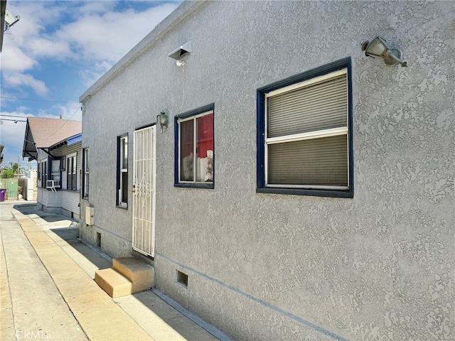 view of property exterior with a patio and cooling unit