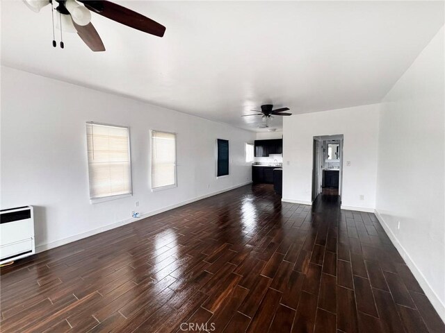 1135 E 3rd St, Long Beach, CA 90802 - unfurnished living room featuring a ceiling fan, dark wood-style floors, baseboards, and heating unit