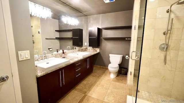 bathroom featuring vanity, an enclosed shower, and toilet