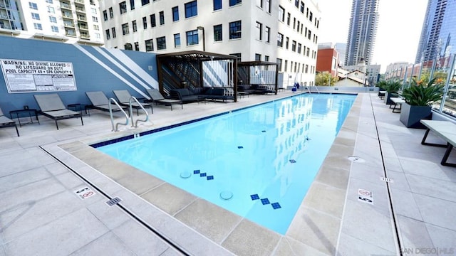 view of swimming pool with a patio area