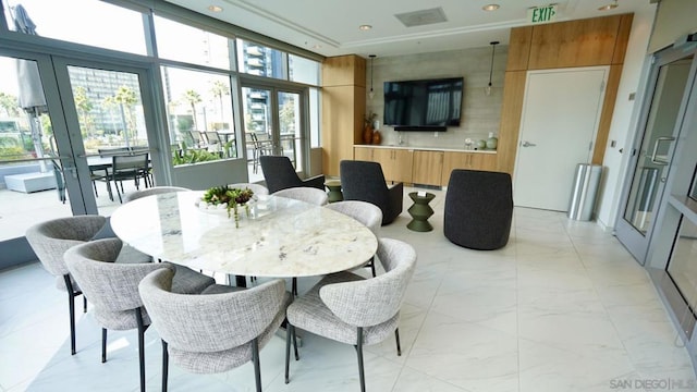 dining space featuring expansive windows, a wealth of natural light, and french doors