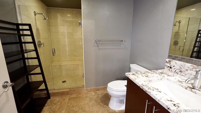 bathroom with vanity, toilet, and a shower with shower door