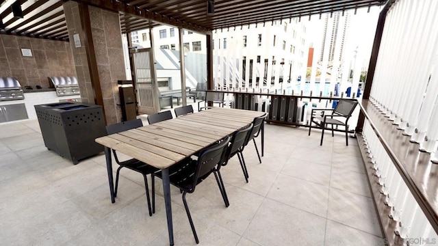 balcony with a pergola, area for grilling, and grilling area