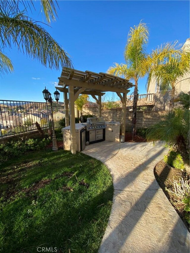 29161 Garnet Canyon Dr, Saugus, CA 91390 - view of community with fence, a pergola, exterior kitchen, and a patio