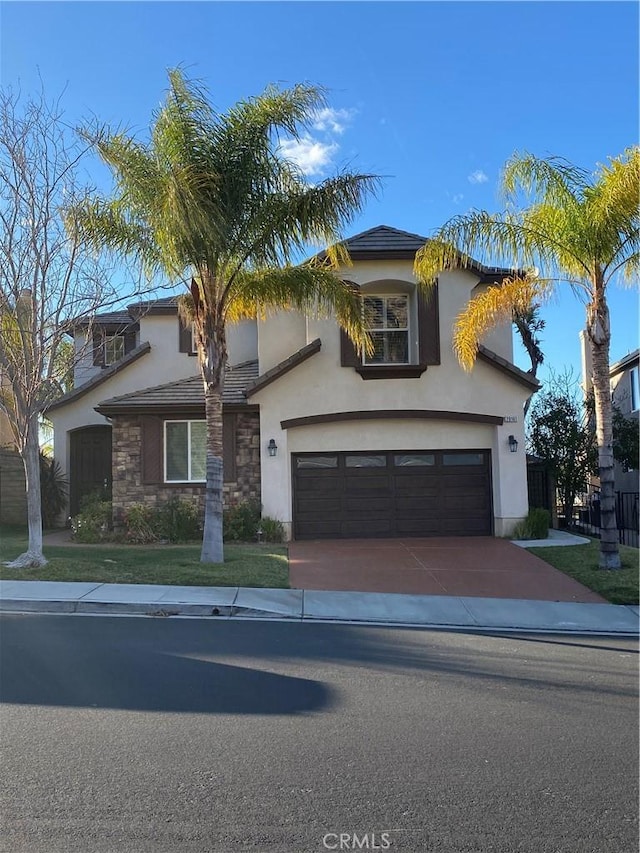 29161 Garnet Canyon Dr, Saugus, CA 91390 - traditional-style house featuring a tiled roof, stucco siding, driveway, stone siding, and a garage
