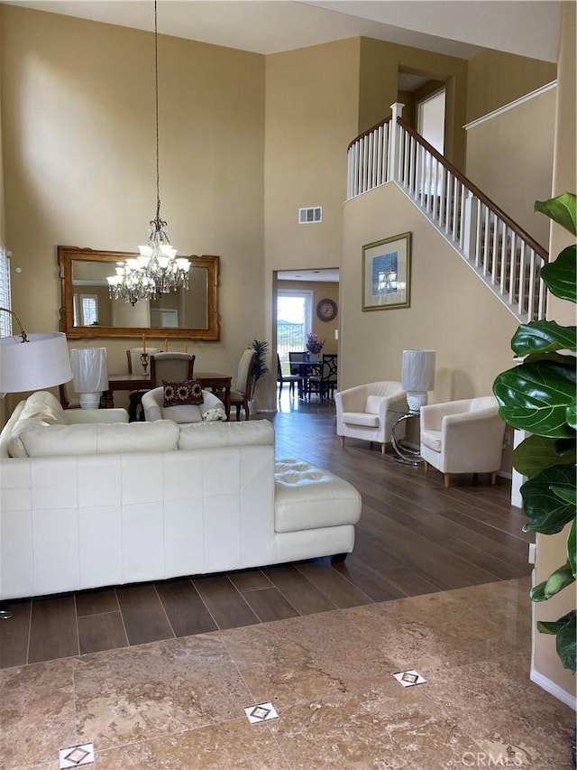 29161 Garnet Canyon Dr, Saugus, CA 91390 - living area with dark wood-style flooring, a towering ceiling, baseboards, visible vents, and an inviting chandelier