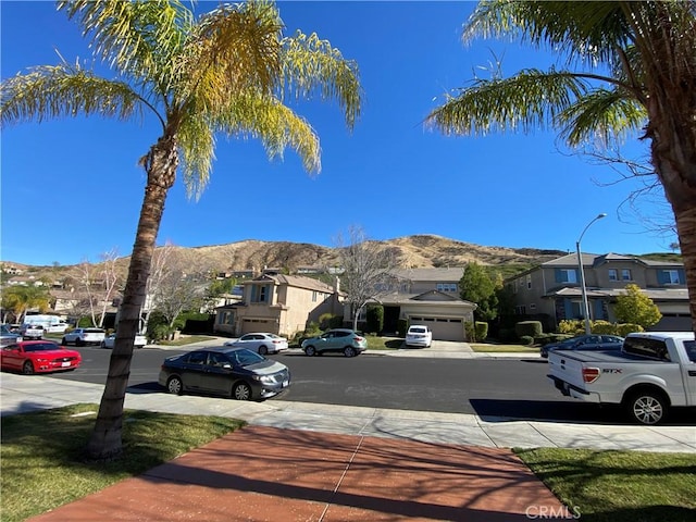29161 Garnet Canyon Dr, Saugus, CA 91390 - view of street with a residential view, street lighting, sidewalks, and a mountain view