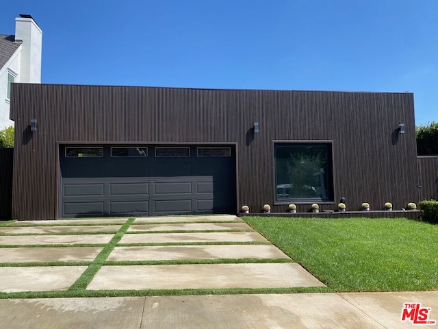 modern home featuring a front yard and a garage