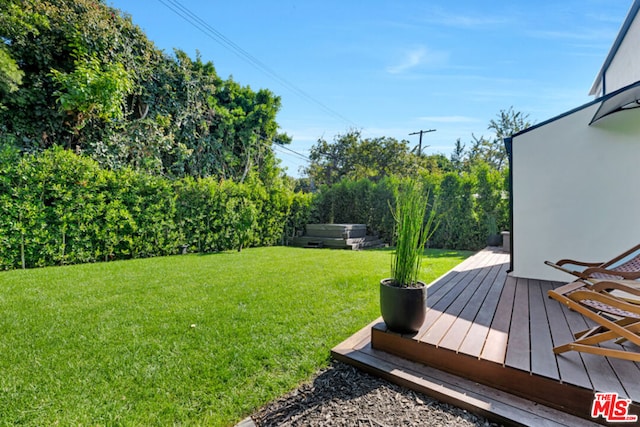 view of yard with a wooden deck and a hot tub