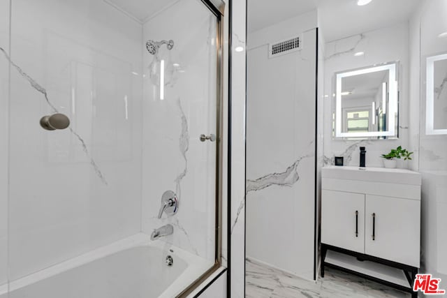 bathroom with vanity and tiled shower / bath combo