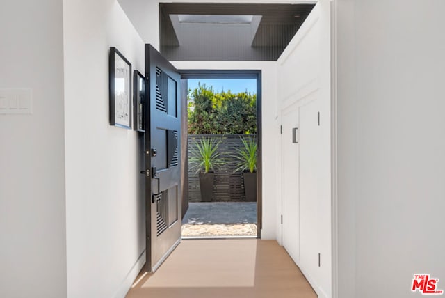 doorway to outside with light hardwood / wood-style floors and a wealth of natural light