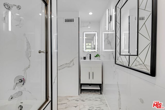 bathroom with vanity and tiled shower / bath combo