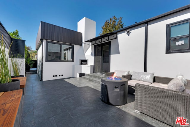 view of patio / terrace featuring an outdoor living space with a fire pit