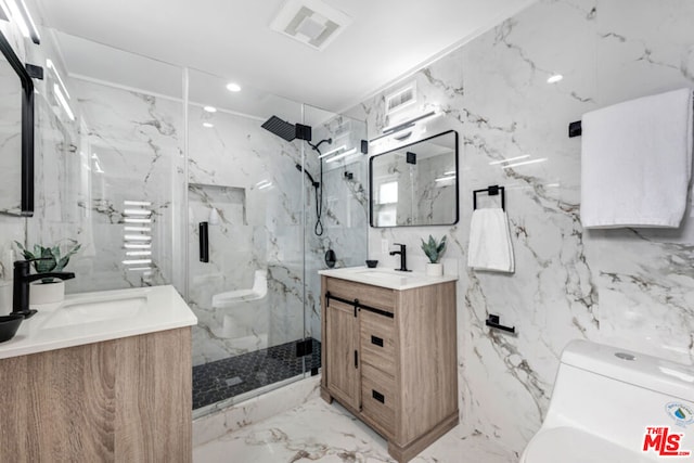 bathroom with vanity, toilet, a shower with shower door, and tile walls