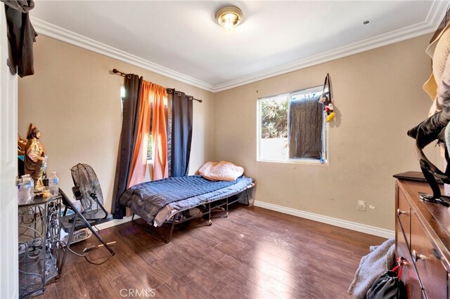 bedroom featuring dark hardwood / wood-style floors and crown molding