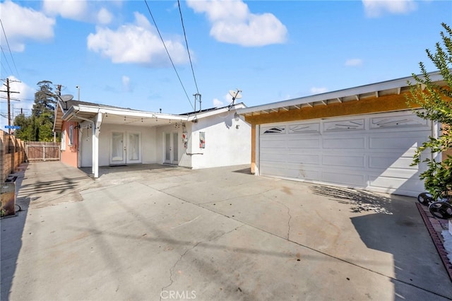 single story home featuring a garage and french doors