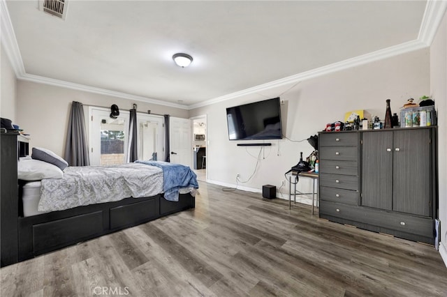 bedroom with hardwood / wood-style flooring and ornamental molding