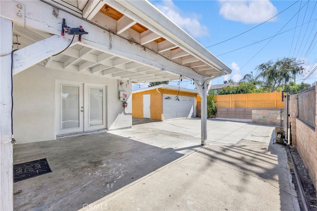 view of patio / terrace with an outbuilding and a garage