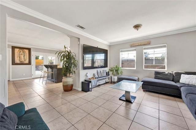 living room with plenty of natural light, ornamental molding, and light tile patterned floors