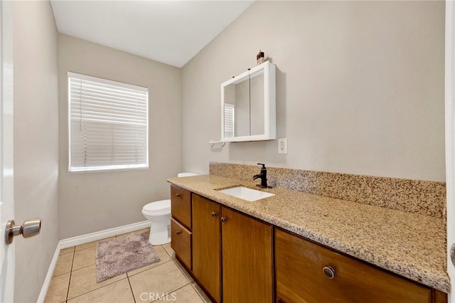 bathroom with tile patterned flooring, vanity, and toilet