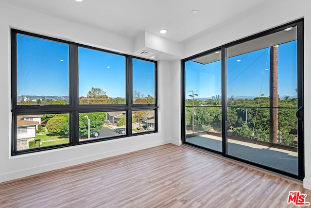 unfurnished room featuring light hardwood / wood-style flooring and a wealth of natural light